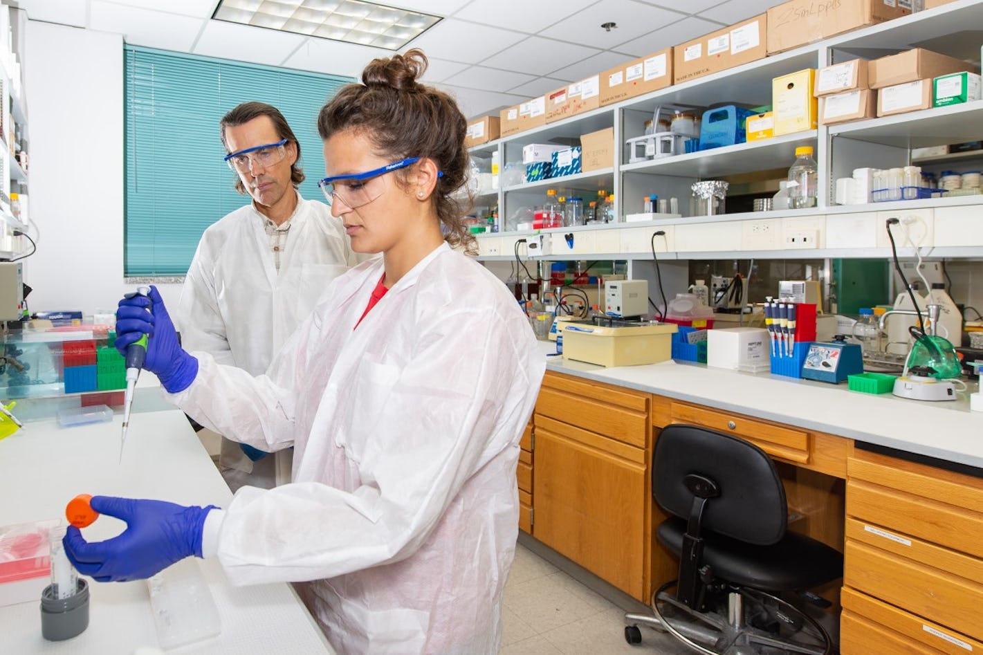 Professor Rick Russell (right) and graduate student Isabel Strohkendl conduct experiments using CRISPR enzymes. Image courtesy of The University of Texas at Austin.